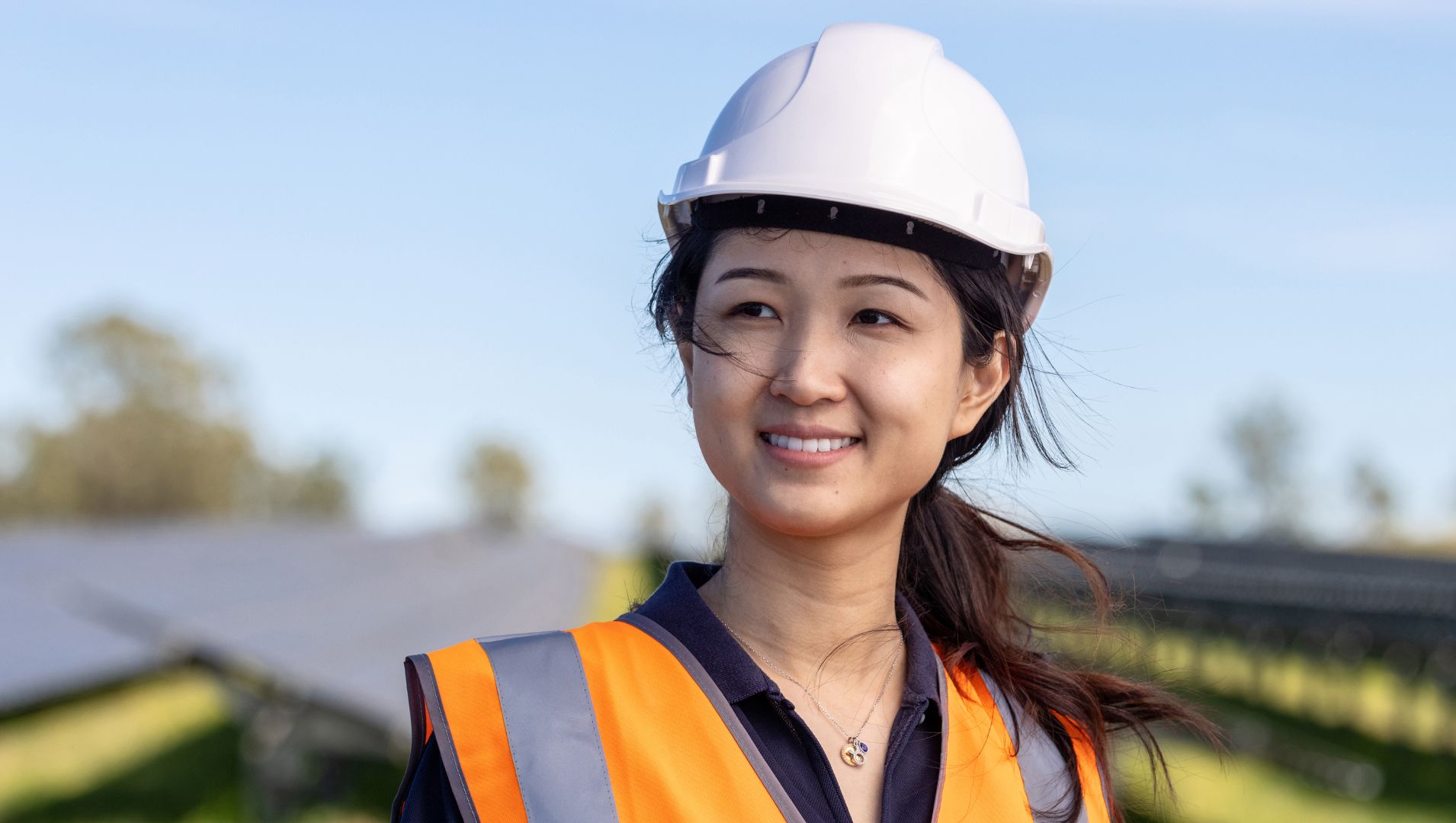 Young woman in hard hat and high vis jacket